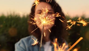young person holding a sparkler