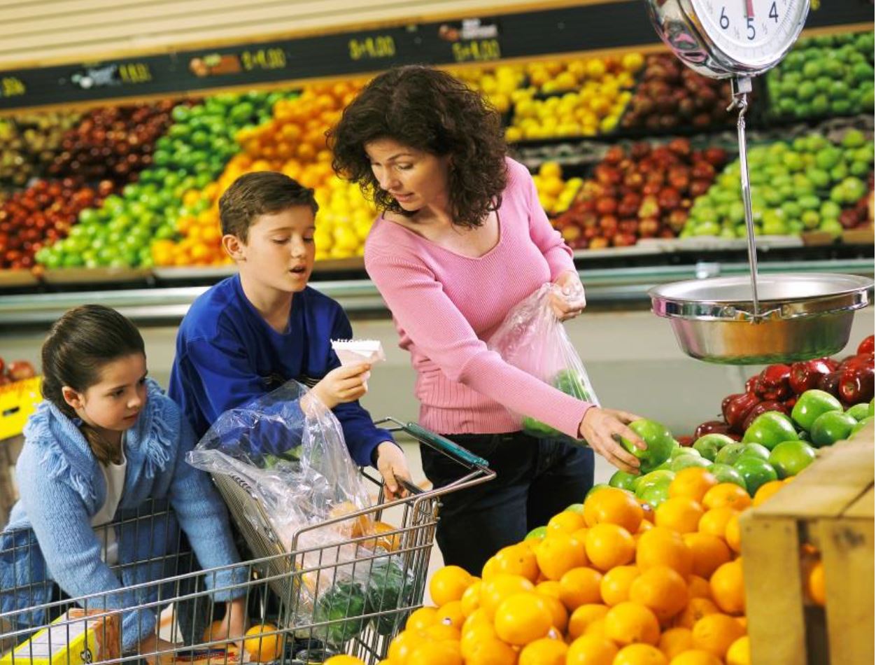 mother with children shopping in grocery store