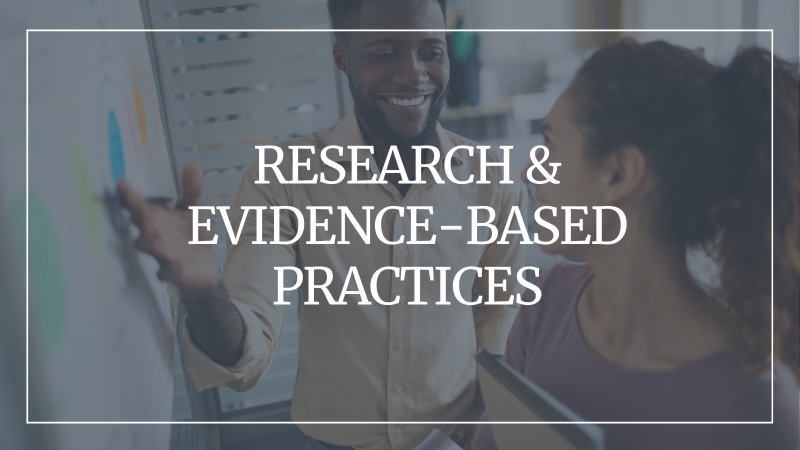 Background image of two people standing in front of a white board smiling with a grey overlay and text that reads: Research & Evidence-Based Practices